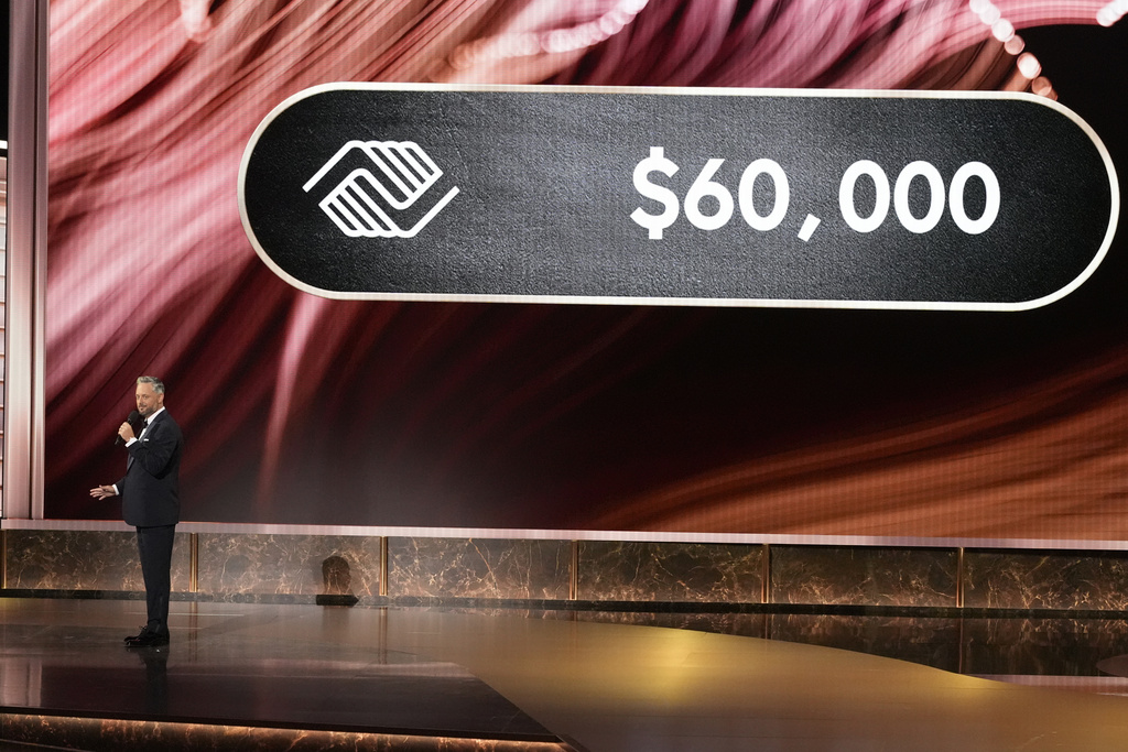 Host Nate Bargatze gives update on Girls & Boys Club donation amount during the 77th Primetime Emmy Awards on Sunday, Sept. 14, 2025, at the Peacock Theater in Los Angeles. (AP Photo/Chris Pizzello)
