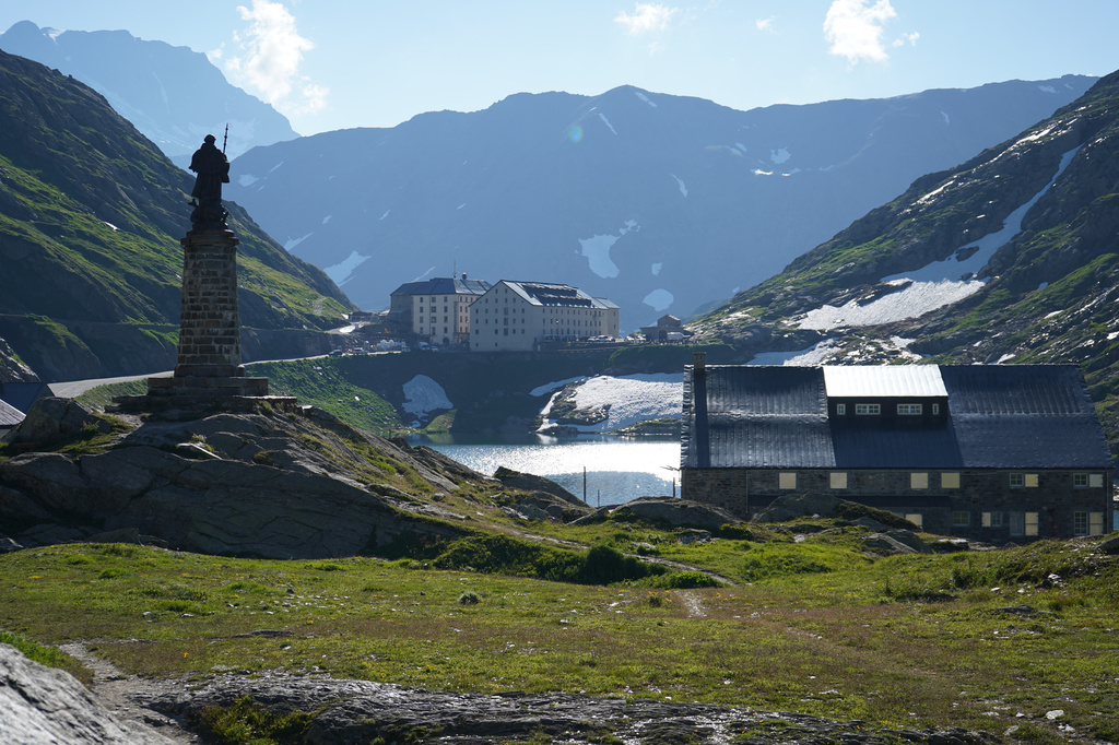 The Statue of St. Bernard and the Great Saint Bernard Lake with the Grand St. Bernard hospice are pictured in Saint-Rhemy, Italy, Tuesday, June 23, 2026. (AP Photo/Jez Fielder)