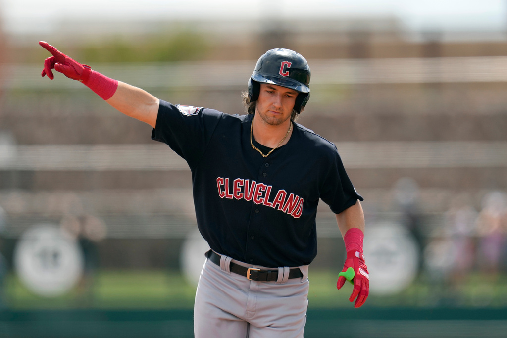 FILE - Cleveland Guardians' Chase DeLauter points as he rounds the bases after hitting a three-run home run against the Chicago White Sox during the first inning of a spring training baseball game, March 18, 2024, in Phoenix. (AP Photo/Ross D. Franklin, file)