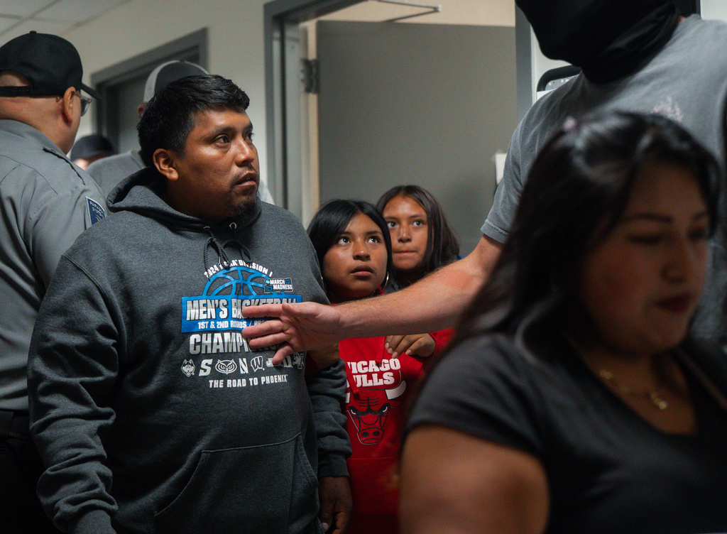Luis, an asylum seeker from Ecuador and father of three children, is detained by federal agents as he exits a courtroom after his immigration hearing, Tuesday, Aug. 26, 2025, in New York. (AP Photo/Olga Fedorova)