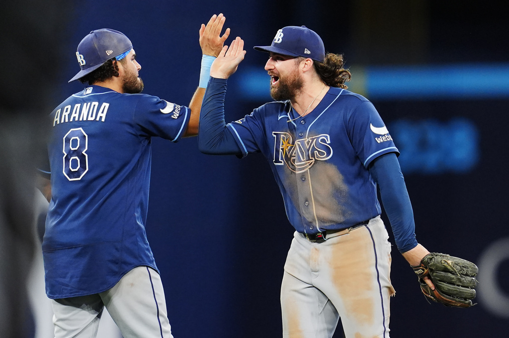 Tampa Bay Rays' Jonathan Aranda (8) and Ryan Vilade (26) celebrate after defeating the Toronto Blue Jays in MLB baseball action in Toronto on Tuesday, May 12, 2026. (Frank Gunn/The Canadian Press via AP)