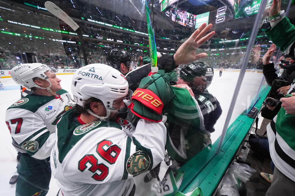 Minnesota Wild right wing Mats Zuccarello (36) and Dallas Stars center Colin Blackwell, right, scuffle at the end of the first period in Game 5 of a first-round NHL Stanley Cup playoffs hockey series, Tuesday, April 28, 2026, in Dallas. (AP Photo/Julio Cortez)