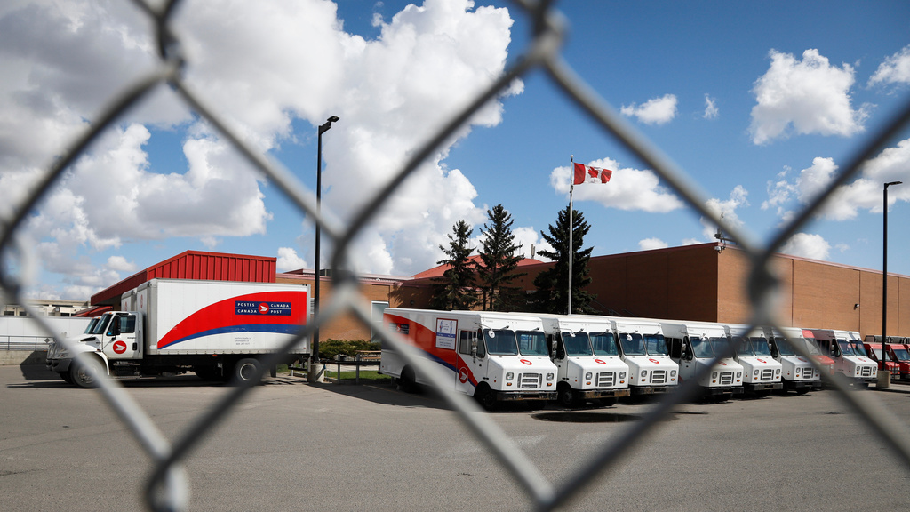 FILE - Delivery vehicles are seen at Canada Post's main plant in Calgary, Alberta, Saturday, May 9, 2020. (Jeff McIntosh/The Canadian Press via AP, File)