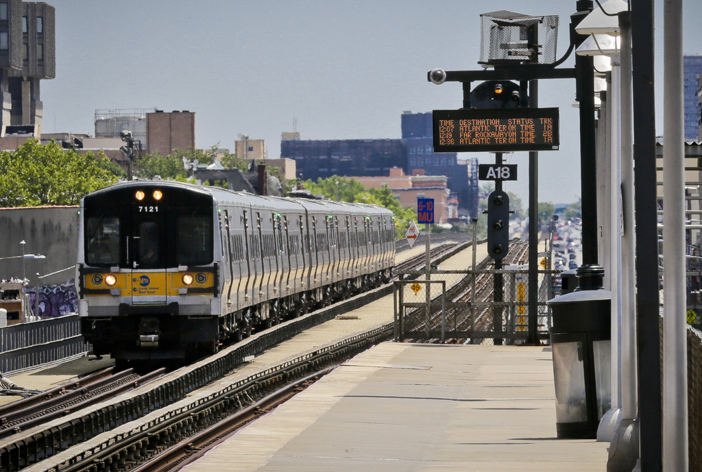 FILE - An Atlantic Terminal bound LIRR train arrives at the Nostrand Avenue station, July 9, 2017, in New York. (AP Photo/Bebeto Matthews, File)
