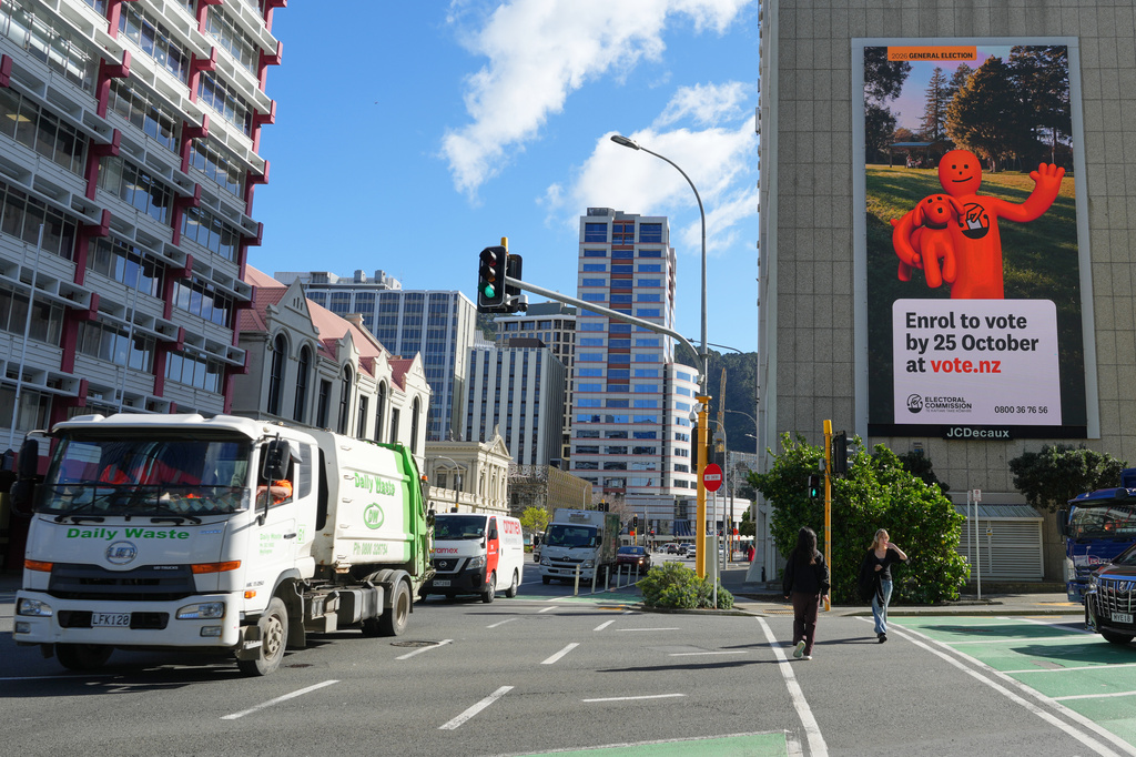 Vehicles move past an Electoral Commission billboard in central Wellington, New Zealand, encouraging voters to enroll, Monday Aug. 10 2026. (AP photo/Charlotte Graham-McLay)