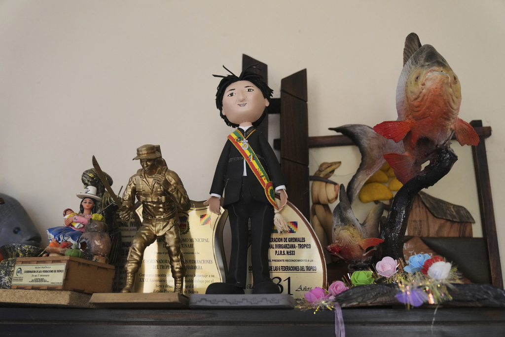 A doll adorned with a miniature presidential depicting former President Evo Morales, who is promoting a null vote campaign in the presidential and legislative elections, sits on a shelf in his office during an interview in Lauca N, Chapare region, Bolivia, Saturday, Aug. 16, 2025. (AP Photo/Jorge Saenz)