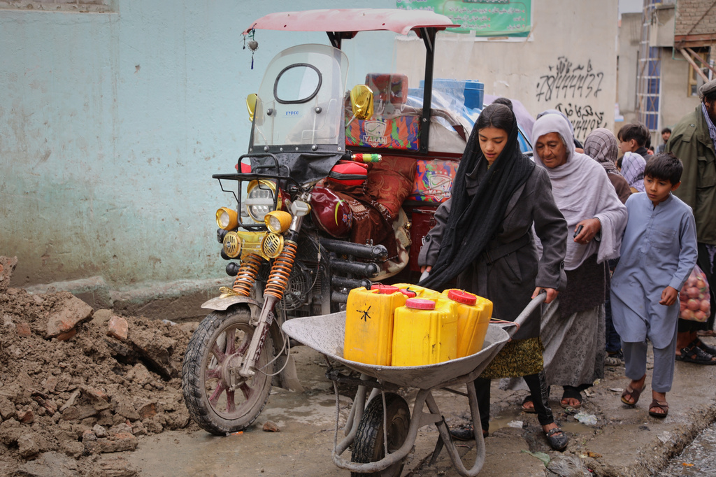 A girl carries jerrycans on a wheelbarrow after collecting water from a well at a mosque in Deh Mazang, Kabul, Afghanistan, Thursday, April 2, 2026. (AP Photo/Siddiqullah Alizai)