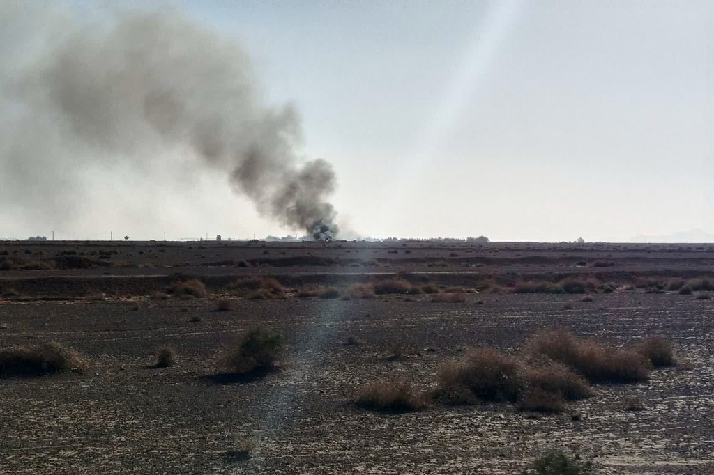 In this image provided by Sepahnews, the Iranian Revolutionary Guard's official website, black smoke rises into the air at what Iran's state TV claimed was the site where an American transport plane and two helicopters involved in a rescue operation were shot down, in Isfahan province, Iran, April, 2026. (Sepahnews via AP)