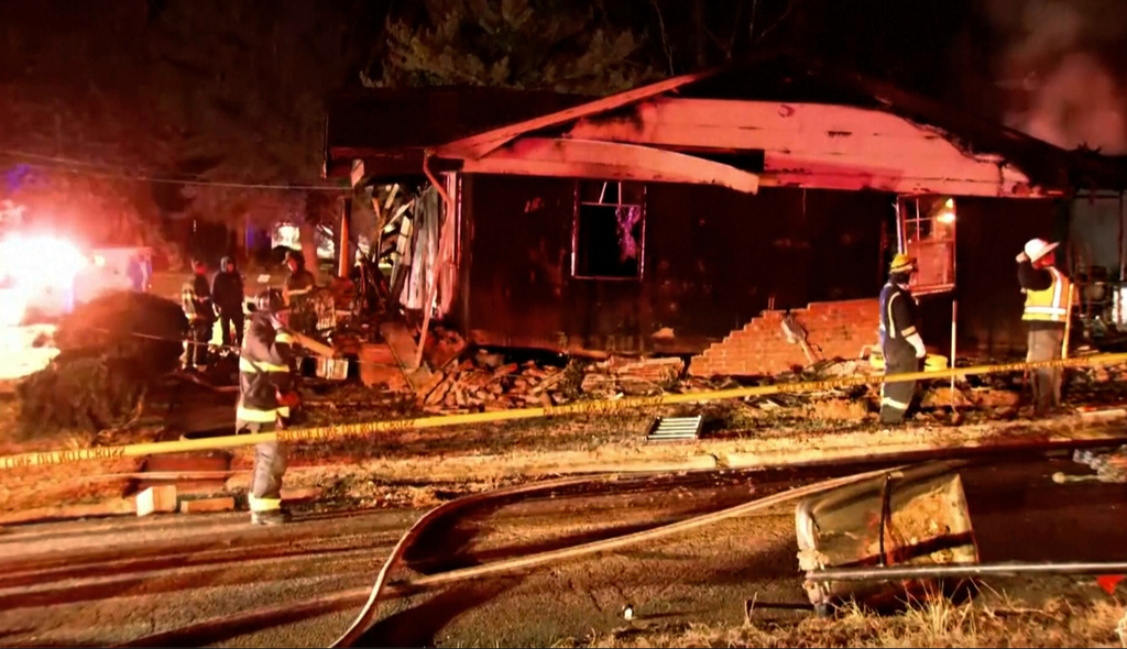 Firefighters look over the scene of a house fire explosion late Monday, Dec. 15, 2025 in Salisbury, N.C. (WSOC via AP)
