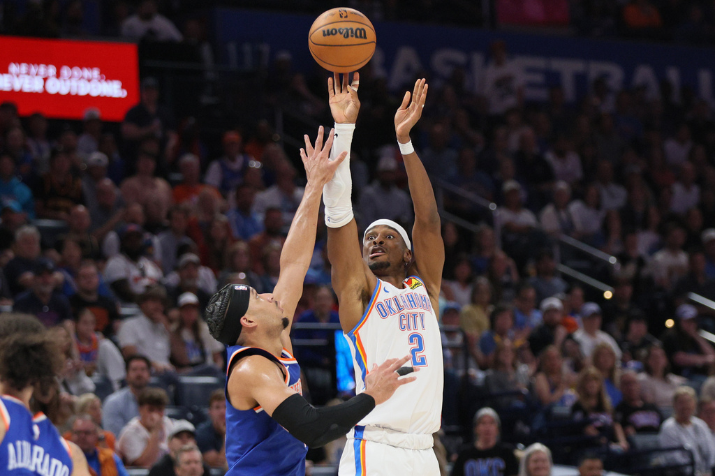Oklahoma City Thunder guard Shai Gilgeous-Alexander (2) shoots over New York Knicks guard Josh Hart, left, during the second half of an NBA basketball game Sunday, March 29, 2026, in Oklahoma City. (AP Photo/Nate Billings)