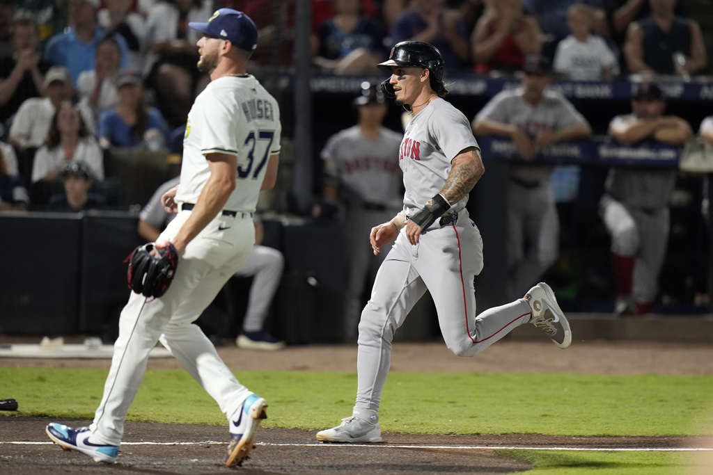 Boston Red Sox's Jarren Duran scores on a wild pitch by Tampa Bay Rays pitcher Adrian Houser (37) during the third inning of a baseball game Saturday, Sept. 20, 2025, in Tampa, Fla. (AP Photo/Chris O'Meara)