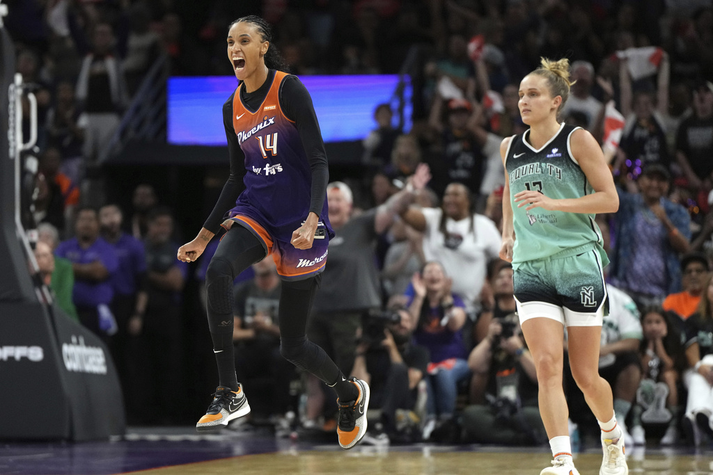 Phoenix Mercury forward DeWanna Bonner (14) celebrates after scoring against New York Liberty forward Leonie Fiebich, right, during the second half of Game 3 in the first round of the WNBA basketball playoffs, Friday, Sept. 19, 2025, in Phoenix. (AP Photo/Rick Scuteri)