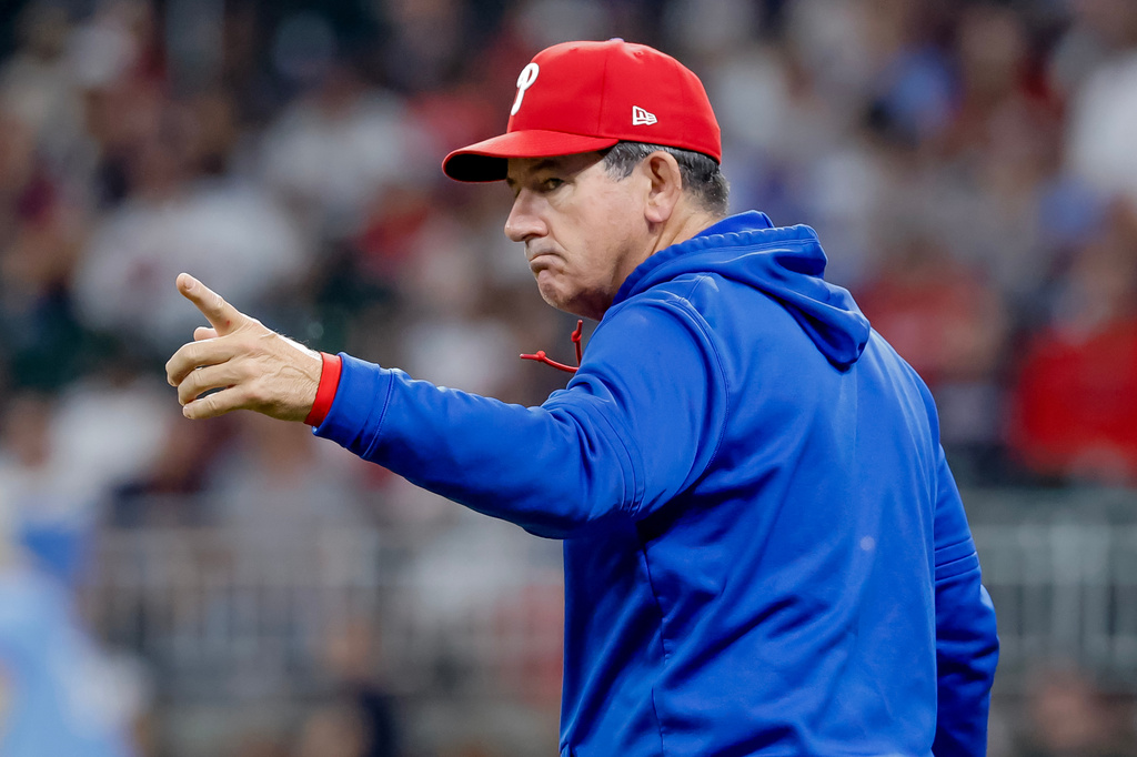 Philadelphia Phillies manager Rob Thomson signals to change pitchers against the Atlanta Braves during the seventh inning of a baseball game, Saturday, April 25, 2026, in Atlanta. (AP Photo/Erik S. Lesser)