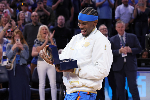 Oklahoma City Thunder guard Shai Gilgeous-Alexander looks at his championship ring during a ceremony before an NBA basketball game against the Houston Rockets Tuesday, Oct. 21, 2025, in Oklahoma City. (AP Photo/Nate Billings) Oklahoma City Thunder guard Shai Gilgeous-Alexander looks at his championship ring during a ceremony before an NBA basketball game against the Houston Rockets Tuesday, Oct. 21, 2025, in Oklahoma City. (AP Photo/Nate Billings)