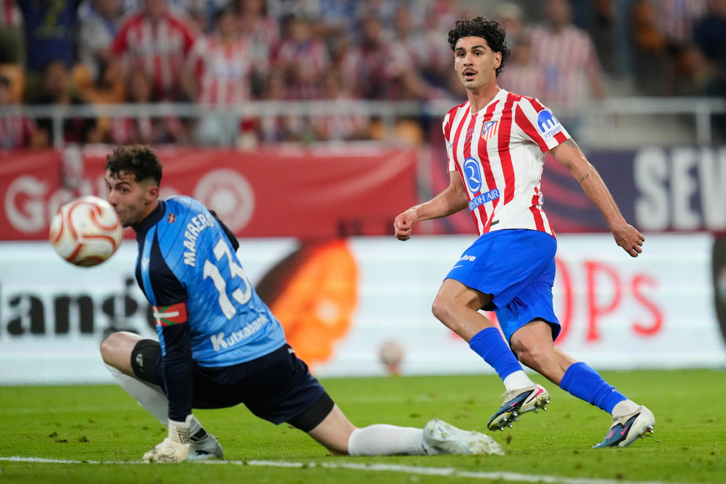 Atletico Madrid's Johnny Cardoso, right, shoots the ball past Real Sociedad's goalkeeper Unai Marrero during the Copa del Rey final soccer match between Atletico Madrid and Real Sociedad in Seville, Spain, Saturday, April. 18, 2026. (AP Photo/Jose Breton)