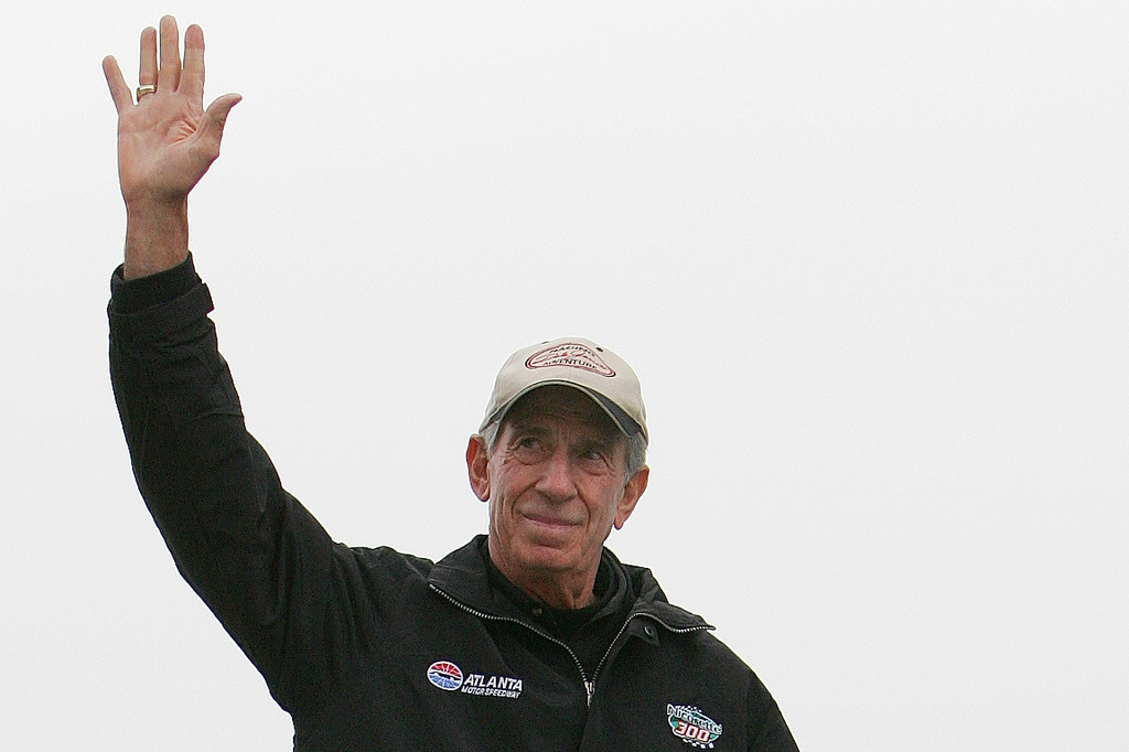 FILE - NASCAR legend Ned Jarrett waves to the fans as he is introduced before the start of the NASCAR BUSCH Nicorette 300 at Atlanta Motor Speedway in Hampton, Ga., March 18, 2006. (AP Photo/John Amis, File)