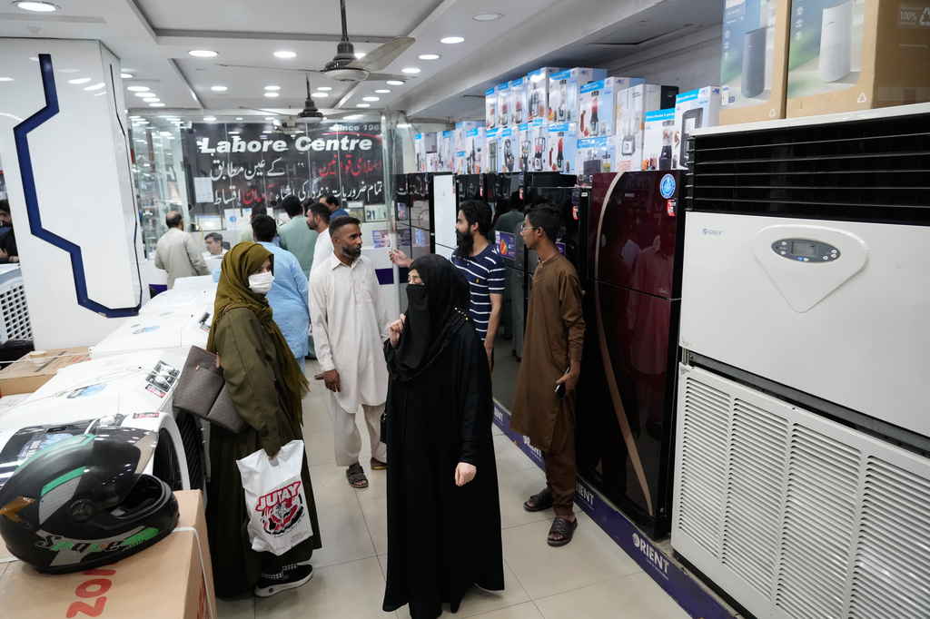 People visit a store to buy home appliances, in Lahore, Pakistan, Friday, June 12, 2026. (AP Photo/K.M. Chaudary)