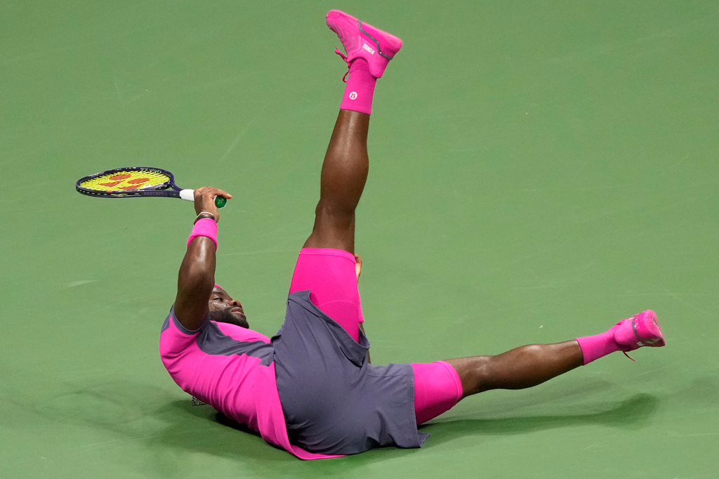 Frances Tiafoe, of the United States, falls as he attempts a shot to Ben Shelton, of the United States, during the men's singles semifinals of the U.S. Open tennis championships Friday, Sept. 11, 2026, in New York. (AP Photo/Yuki Iwamura)