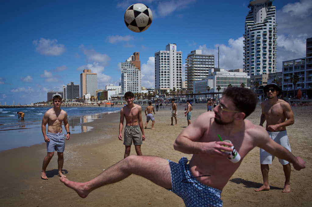 People play on the beachfront in Tel Aviv, Israel, after the announcement of a two-week ceasefire with Iran, Wednesday, April 8, 2026. (AP Photo/Oded Balilty)