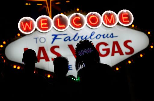 FILE - Runners stop to to have photos taken by official photographers at the Welcome to Las Vegas sign during the Rock 'n' Roll Las Vegas Marathon, Sunday, Nov. 12, 2017, in Las Vegas. (AP Photo/John Locher, File) FILE - Runners stop to to have photos taken by official photographers at the Welcome to Las Vegas sign during the Rock 'n' Roll Las Vegas Marathon, Sunday, Nov. 12, 2017, in Las Vegas. (AP Photo/John Locher, File)