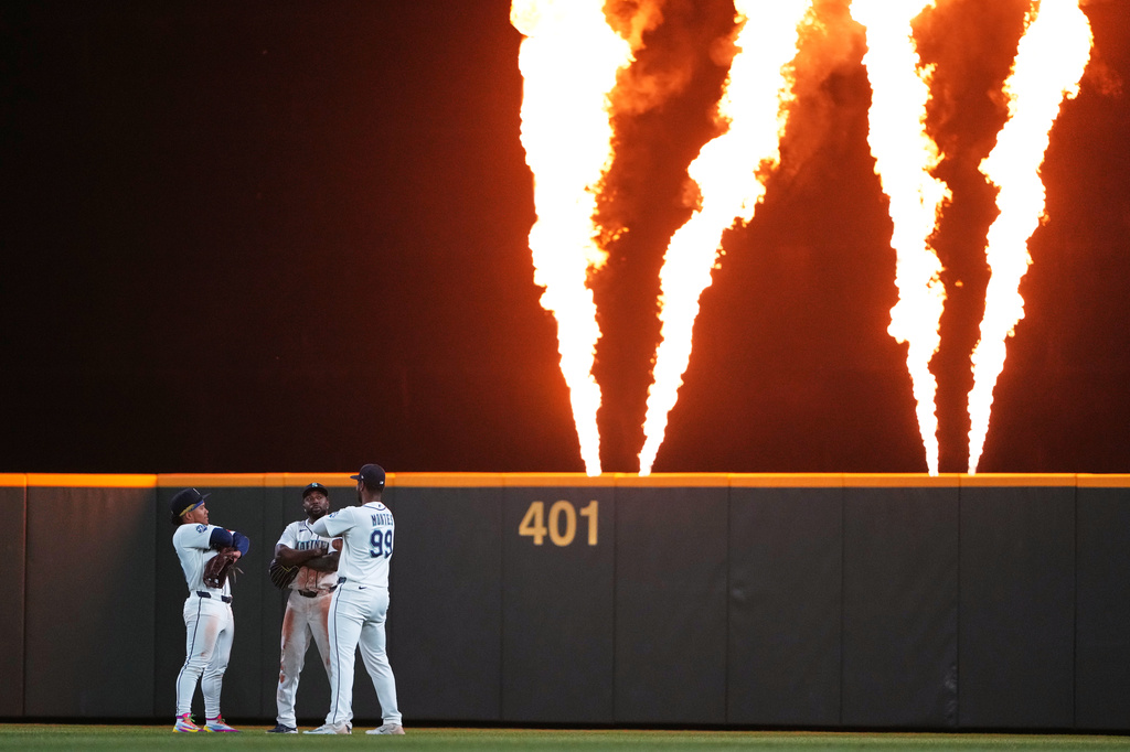 Seattle Mariners left fielder Michael Arroyo, center fielder Randy Arozarena and right fielder Lazaro Montes celebrate a win over the Los Angeles Angels in a baseball game, Saturday, Sept. 26, 2026, in Seattle. (AP Photo/Lindsey Wasson)