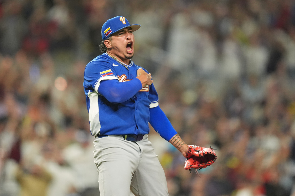 Venezuela pitcher Daniel Palencia reacts after the team defeats Italy during a World Baseball Classic semifinal game, Monday, March 16, 2026, in Miami. (AP Photo/Rebecca Blackwell)