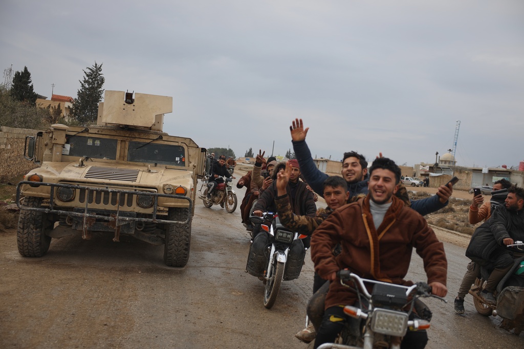 FILE - People celebrate as Syrian government forces enter the town of Deir Hafer, Saturday, Jan. 17, 2026, following the withdrawal of the U.S.-backed Syrian Democratic Forces. (AP Photo/Omar Albam, File)