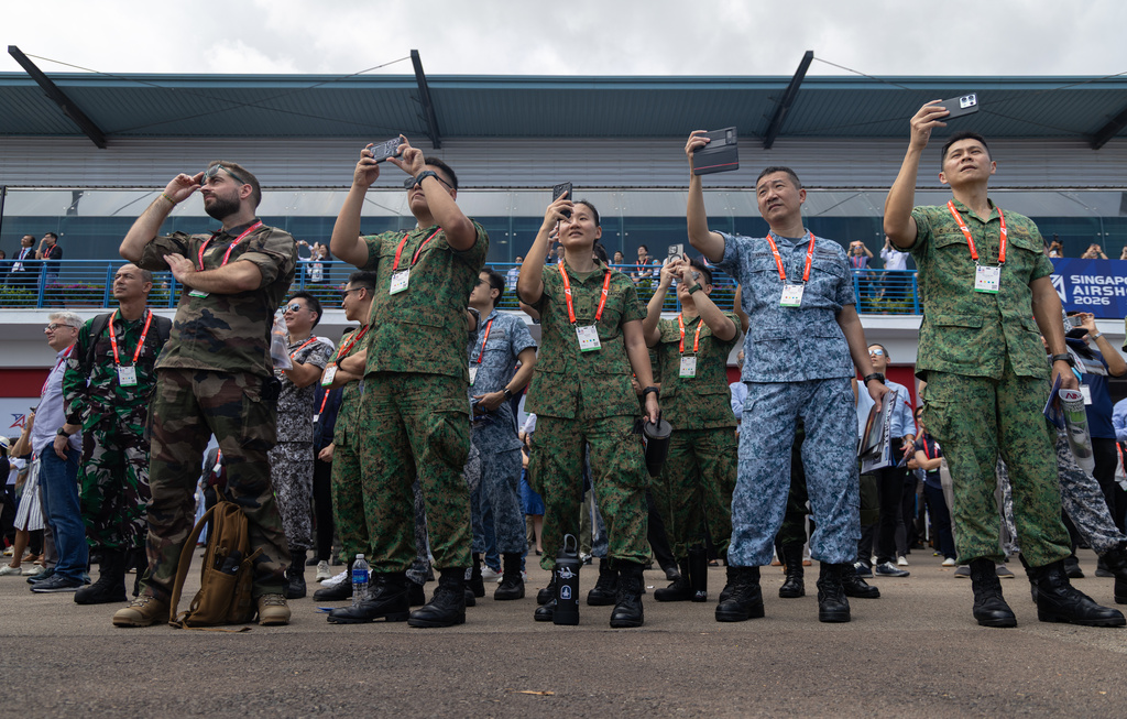 Members of the Singapore Armed Forces, along with others, watch an air display at the Singapore Air Show on Thursday, Feb. 5, 2026. (AP Photo/Anton L. Delgado)