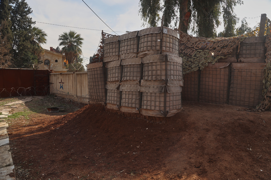 Defensive barriers stand inside part of a Russian military base near Qamishli International Airport in northeastern Syria, Tuesday, Jan. 27, 2026, as Russian forces have begun withdrawing from sections of the facility. (AP Photo/Baderkhan Ahmad)