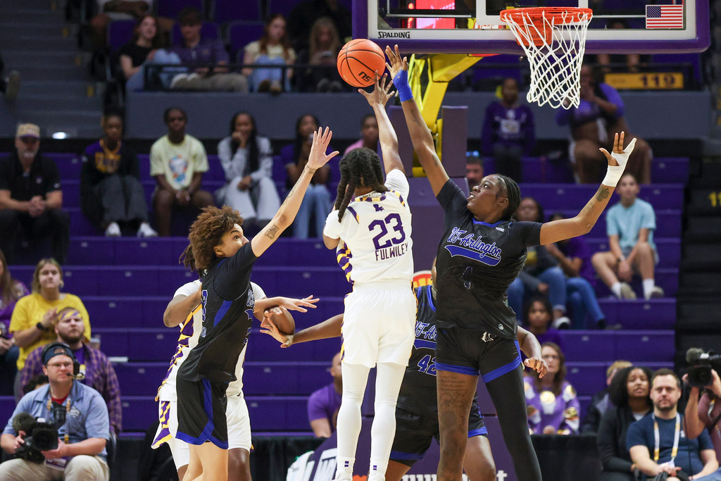 LSU guard Milaysia Fulwiley (23) passes the ball to a teammate between Texas-Arlington guard Jadyn Atchison (13) and forward Laura Bello (4) in the first half of an NCAA college basketball game between Texas-Arlington and LSU in Baton Rouge, La., Sunday, Dec. 21, 2025. (AP Photo/Peter Forest)