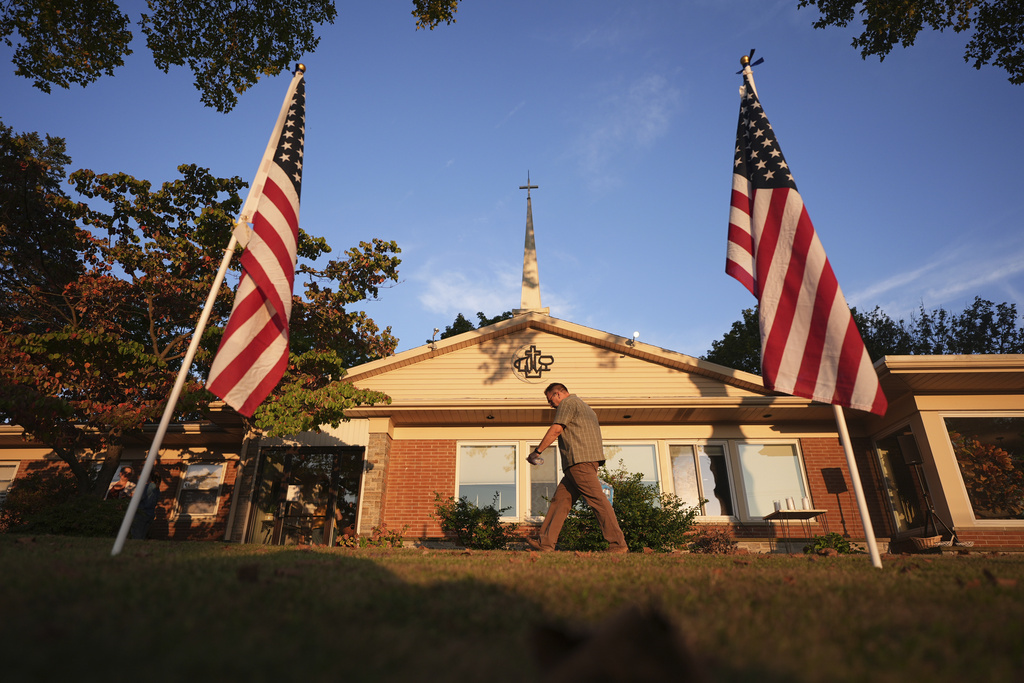 An attendee walks outside Spring Grove Alliance church before a vigil Thursday, Sept. 18, 2025, in Spring Grove, Pa., after multiple police officers were shot and killed. (AP Photo/Matt Slocum)