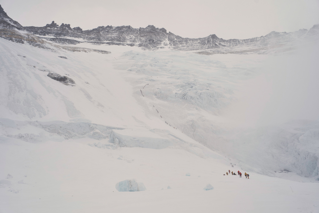 Mountaineers ascend from Lhotse Face to Camp 1 on their way to the summit of Mount Everest in Nepal, Friday, May 8, 2026. (AP Photo/Pasang Rinzee Sherpa)