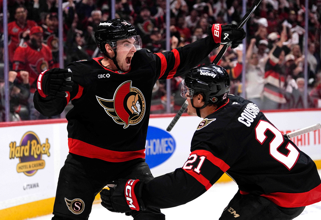 FILE - Ottawa Senators' Drake Batherson (19) celebrates his goal against the Carolina Hurricanes with teammate Nick Cousins (21) during the second period of an NHL hockey playoff game in Ottawa, Ontario, April 23, 2026. (Justin Tang/The Canadian Press via AP, File)