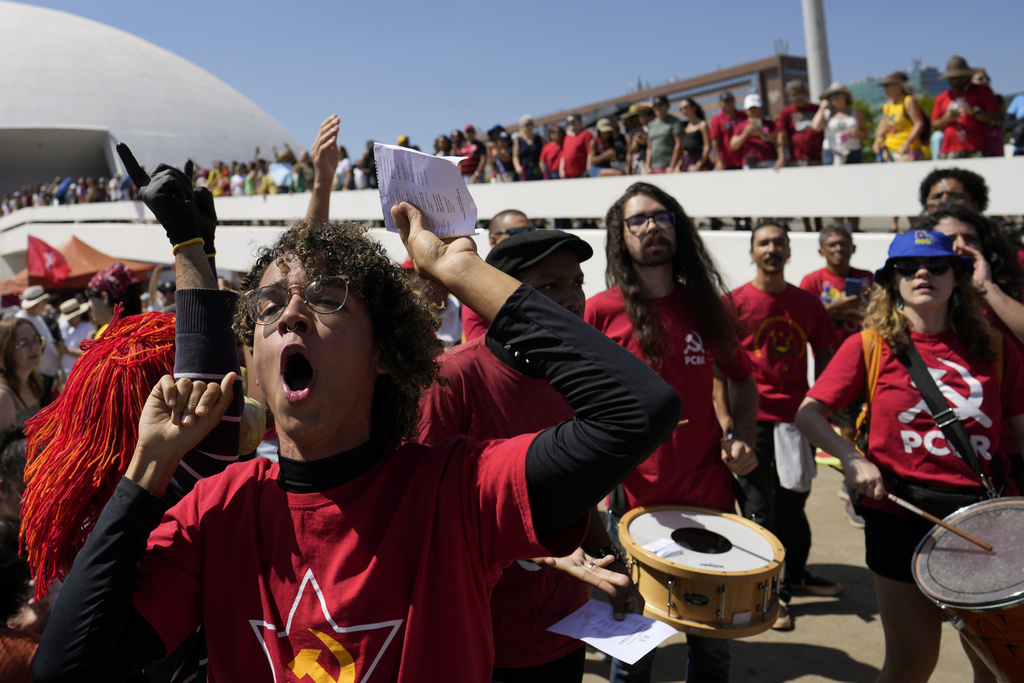 Demonstrators chant "No amnesty" during a protest against an amnesty bill that could benefit former President Jair Bolsonaro and his allies convicted for a 2023 coup attempt, in Brasilia, Brazil, Sunday, Sept. 21, 2025. (AP Photo/Eraldo Peres)