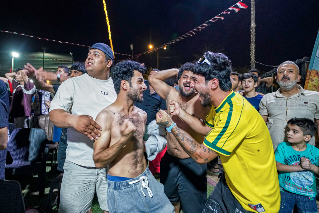 Iraqi soccer fans react after Iraq scored as they watch the World Cup match between Iraq and Norway on a large screen in downtown Baghdad, Iraq, early Wednesday, June 17, 2026. (AP Photo/Anmar Khalil)