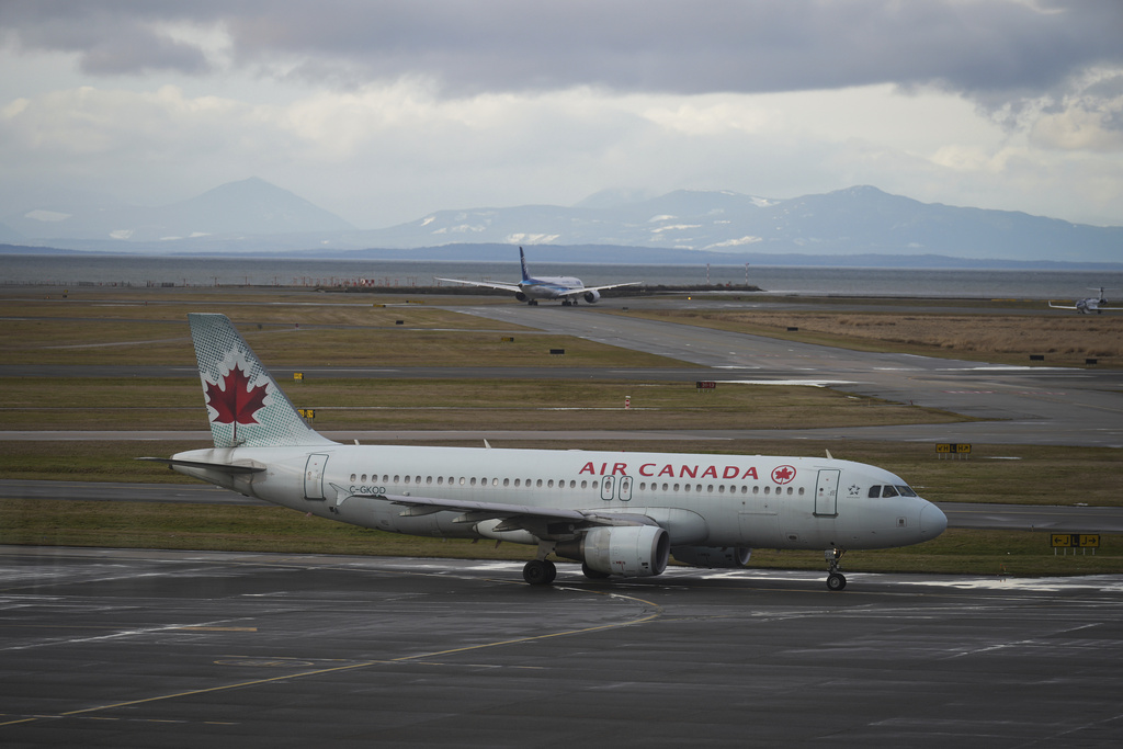 FILE - An Air Canada aircraft taxis at Vancouver International Airport after operations returned to normal after last week's snowstorm, in Richmond, British Columbia, on Monday, Dec. 26, 2022. (Darryl Dyck/The Canadian Press via AP, File