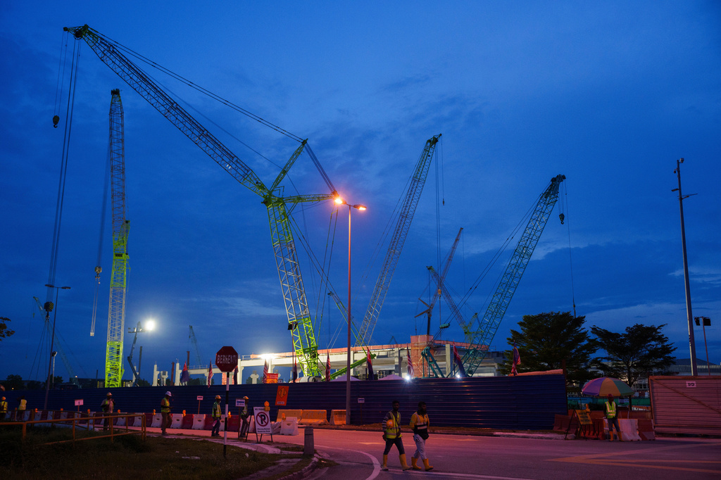 FILE - Workers walk outside a data center building under construction in Johor Bahru town at Johor state, Sept. 28, 2024. (AP Photo/Vincent Thian, File)