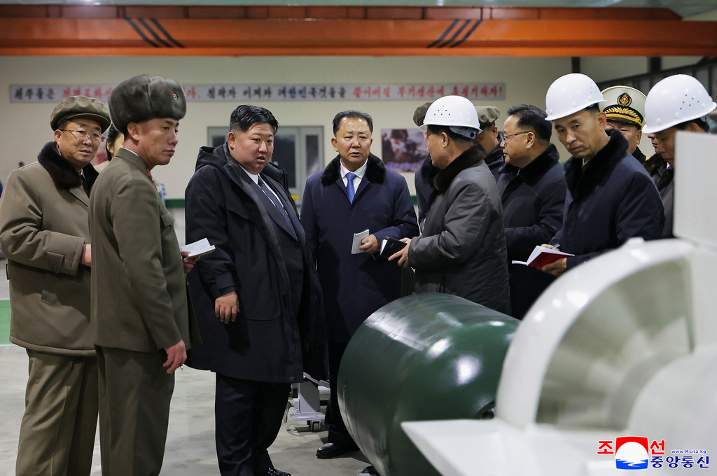In this undated photo provided Thursday, Dec. 25, 2025, by the North Korean government, its leader Kim Jong Un, third left, visits a shipyard as he inspects a nuclear-powered submarine under construction at an undisclosed location in North Korea. Independent journalists were not given access to cover the event depicted in this image distributed by the North Korean government. The content of this image is as provided and cannot be independently verified. Korean language watermark on image as provided by source reads: "KCNA" which is the abbreviation for Korean Central News Agency. (Korean Central News Agency/Korea News Service via AP)