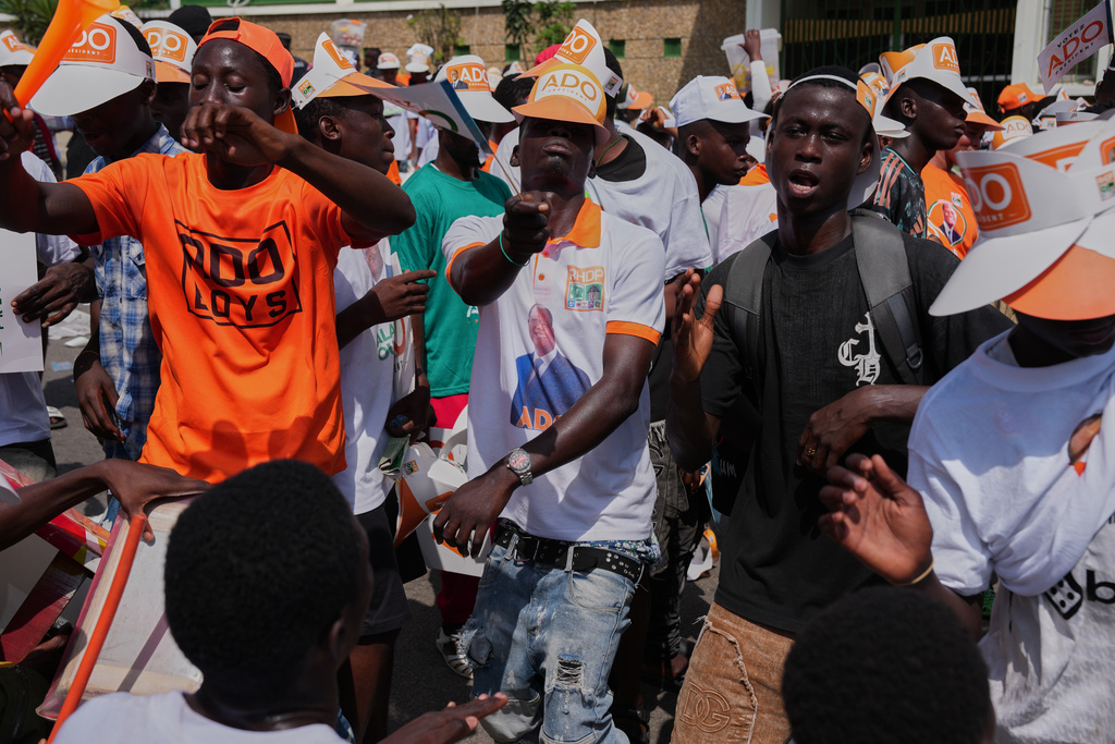Supporters of President Alassane Ouattara dance during a rally in Abidjan, Ivory Coast, Thursday, Oct. 23, 2025. (AP Photo/Misper Apawu)