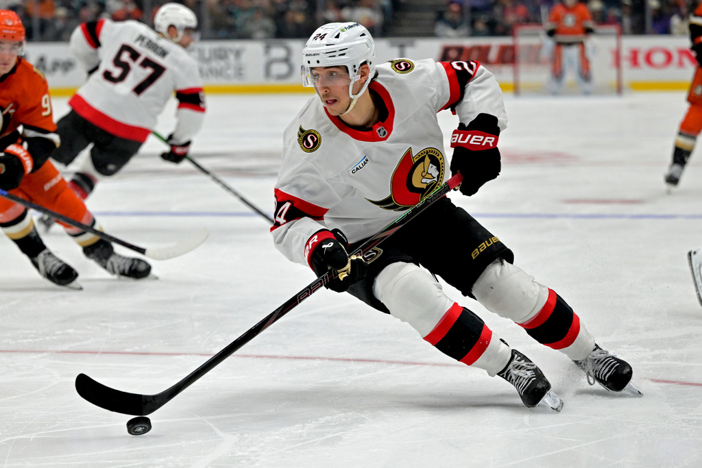 Ottawa Senators center Dylan Cozens handles the puck during the third period of an NHL hockey game against the Anaheim Ducks, Thursday, Nov. 20, 2025, in Anaheim, Calif. (AP Photo/Jayne Kamin-Oncea)