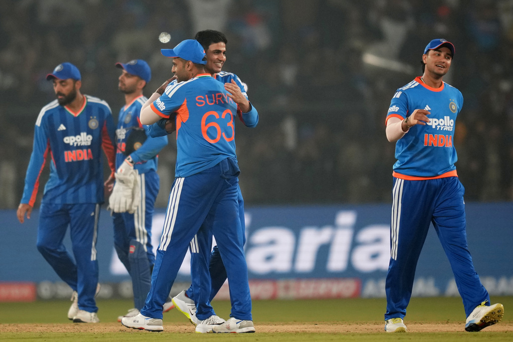 India's captain Suryakumar Yadav, centre, with teammates celebrates after winning the first T20 International cricket match between India and South Africa in Cuttack, India, Tuesday, Dec. 9, 2025. (AP Photo/Rafiq Maqbool)