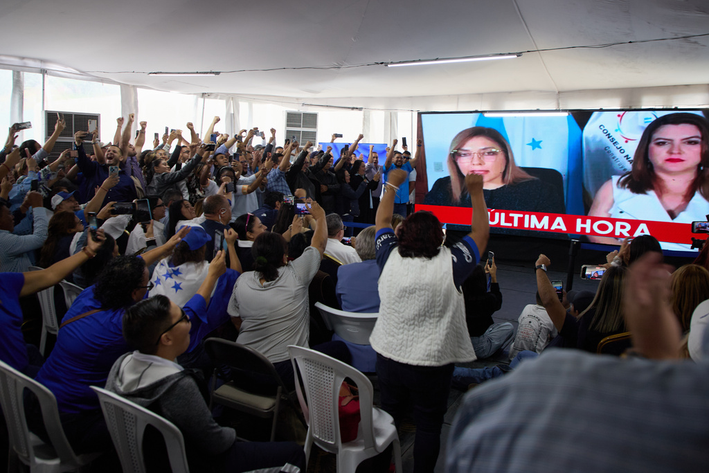 Supporters of the National Party celebrate as the National Electoral Council decelerate presidential candidate Nasry Asfura the winner of Honduras' presidential election in Tegucigalpa, Honduras, Wednesday, Dec. 24, 2025. (AP Photo/Fernando Destephen)