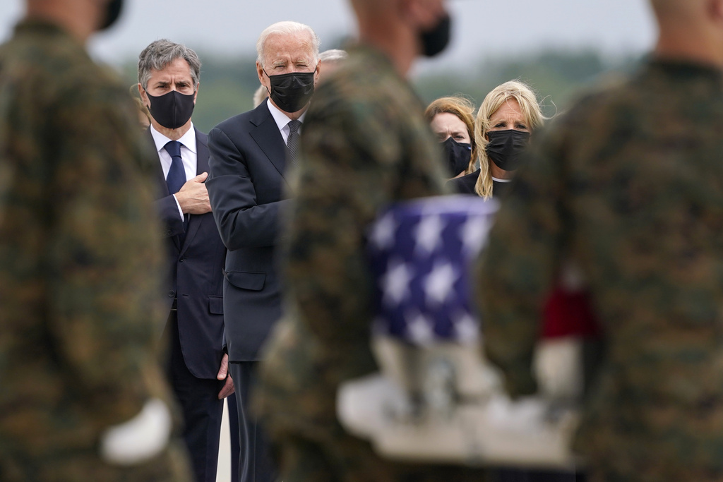 FILE - President Joe Biden, first lady Jill Biden, and Secretary of State Antony Blinken look on as as a carry team moves a transfer case with the remain of Marine Corps Cpl. Humberto A. Sanchez, 22, of Logansport, Ind., during a casualty return at Dover Air Force Base, Del., Aug. 29, 2021, for the 13 service members killed in the suicide bombing in Kabul, Afghanistan, on Aug. 26. (AP Photo/Carolyn Kaster, file)