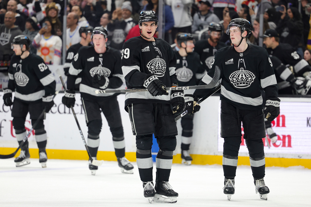 Los Angeles Kings left wing Jeff Malott, left, and defenseman Brandt Clarke celebrate after the team's win against the Calgary Flames in an NHL hockey game Saturday, Feb. 28, 2026 in Los Angeles. (AP Photo/Ryan Sun)