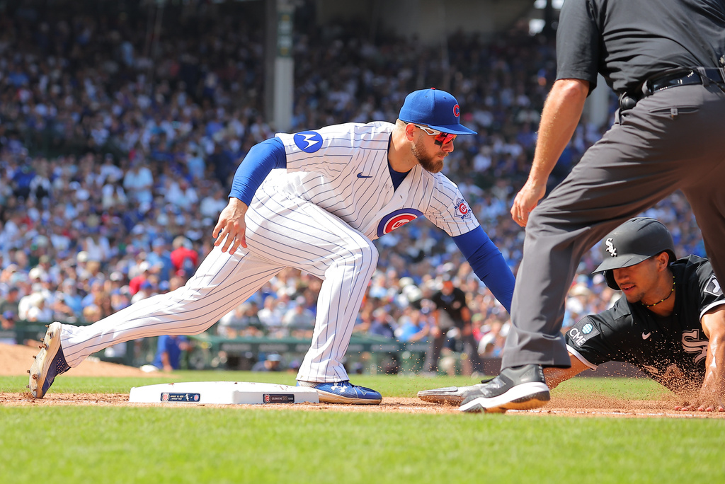 Chicago Cubs' Michael Busch tags out Chicago White Sox's Braden Montgomery at first base on a pick off throw from Caleb Thielba during the sixth inning of a baseball game, Wednesday, Aug. 19, 2026, in Chicago. (AP Photo/Melissa Tamez)