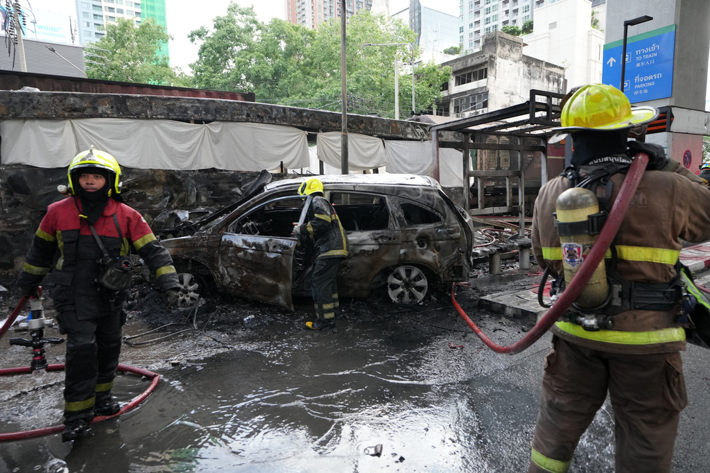 Rescuers work at a train crash site near an airport rail link station in Bangkok, Thailand, Saturday, May 16, 2026. (AP Photo/Sakchai Lalit)