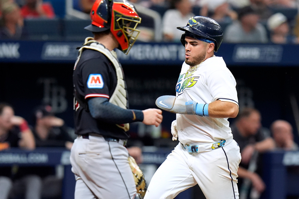 Tampa Bay Rays' Jonathan Aranda, right, scores in front of Cleveland Guardians catcher Patrick Bailey on a sacrifice fly by Cedric Mullins during the fifth inning of a baseball game Saturday, July 25, 2026, in St. Petersburg, Fla. (AP Photo/Chris O'Meara)