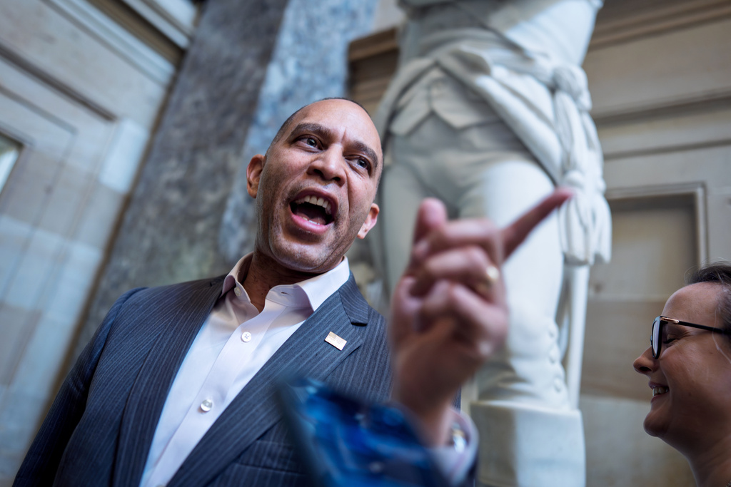 FILE - House Minority Leader Hakeem Jeffries, D-N.Y., disputes a reporter's question as he enters his office on day 24 of the government shutdown, at the Capitol in Washington, Friday, Oct. 24, 2025. (AP Photo/J. Scott Applewhite, File)