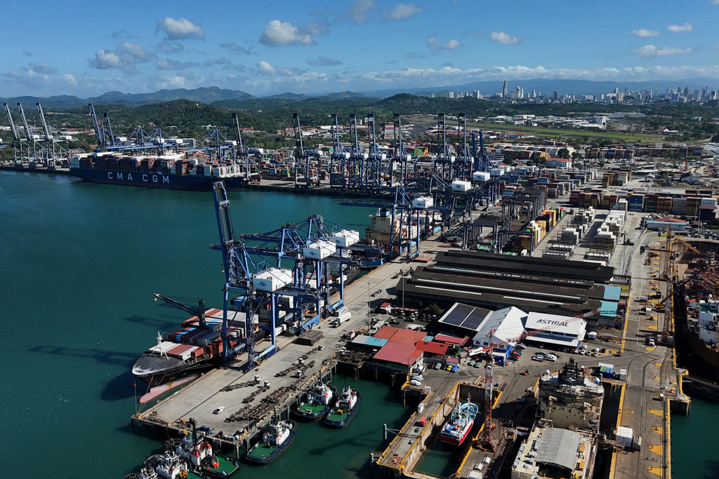 Cranes load a cargo ship at Panama Canal's Port of Balboa, managed by CK Hutchison Holdings, in Panama City, Friday, Jan. 30, 2026. (AP Photo/Matias Delacroix)