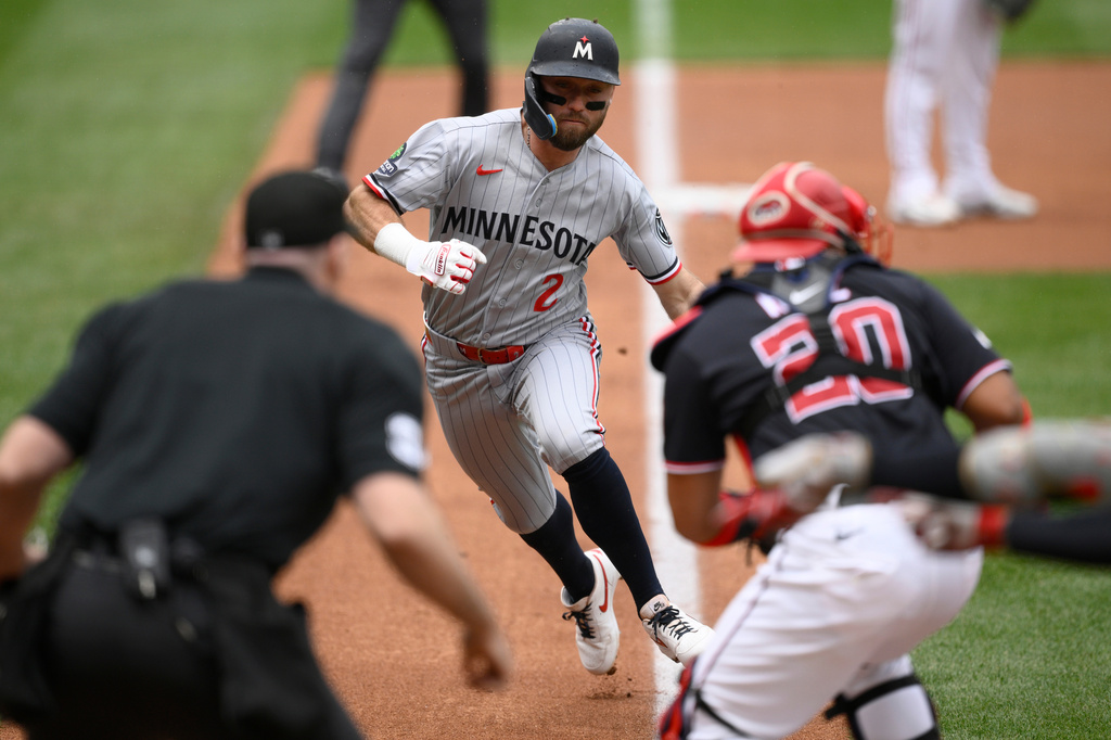 Minnesota Twins' Kody Clemens (2) advances towards home before he was tagged out by Washington Nationals catcher Keibert Ruiz (20) during the second inning of a baseball game, Thursday, May 7, 2026, in Washington. (AP Photo/Nick Wass)